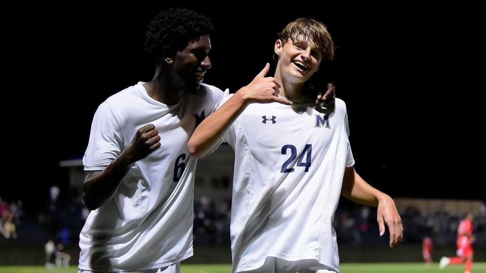 Bobby celebrating with a teammate after a goal